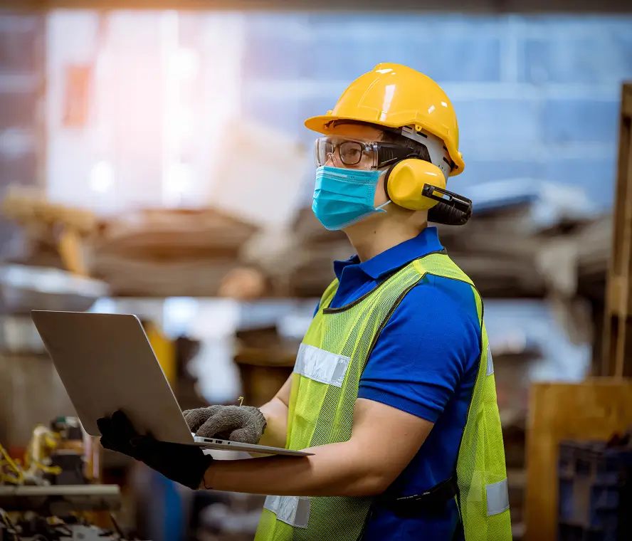 Worker with protective gear looking at site