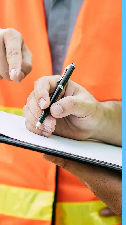 close up of hand writing on clipboard