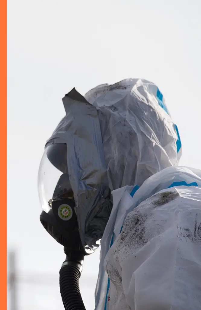 Side shot of worker with protective breathing mask and outfit