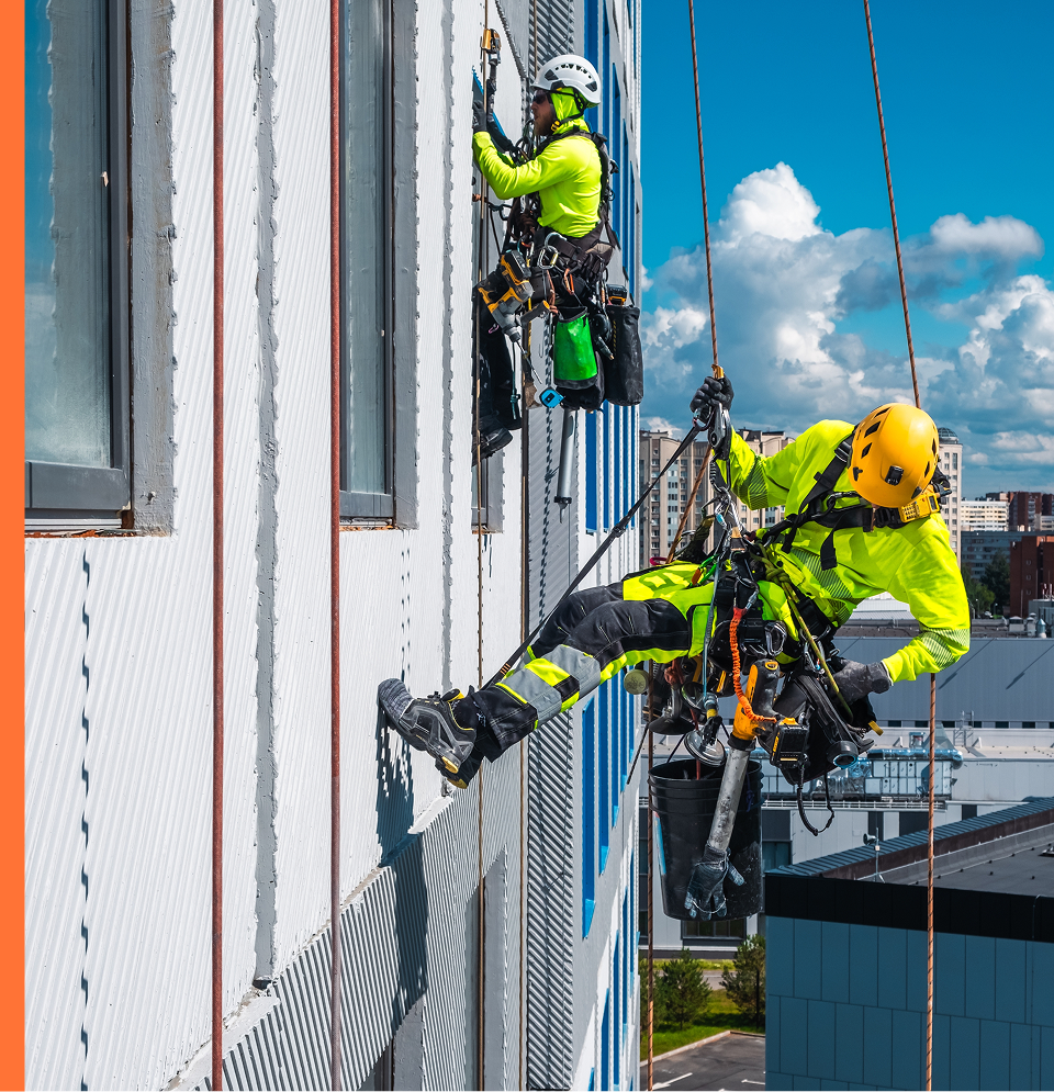 Safety workers scaling the side of a building