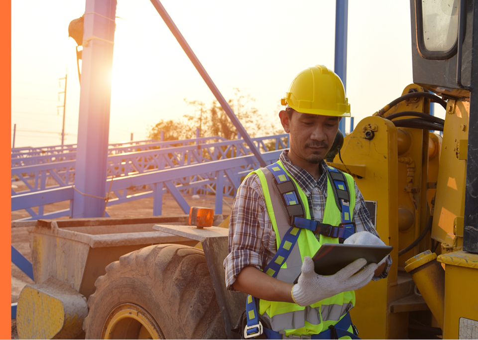Worker in front of construction vehicle