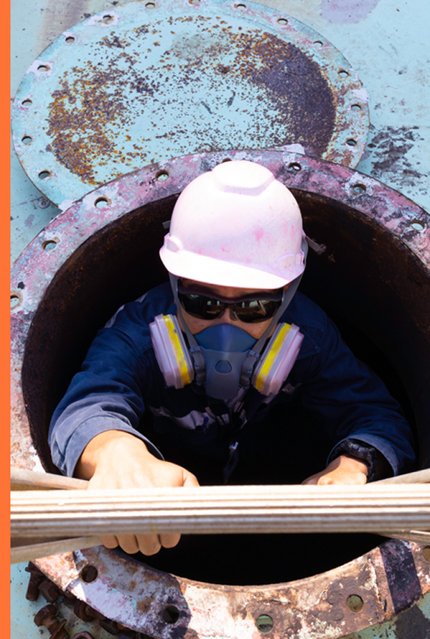 worker with hat climbing out of underground