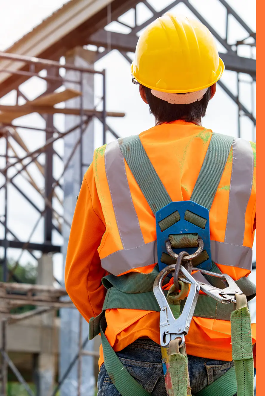 photo of worker looking at construction site from behind