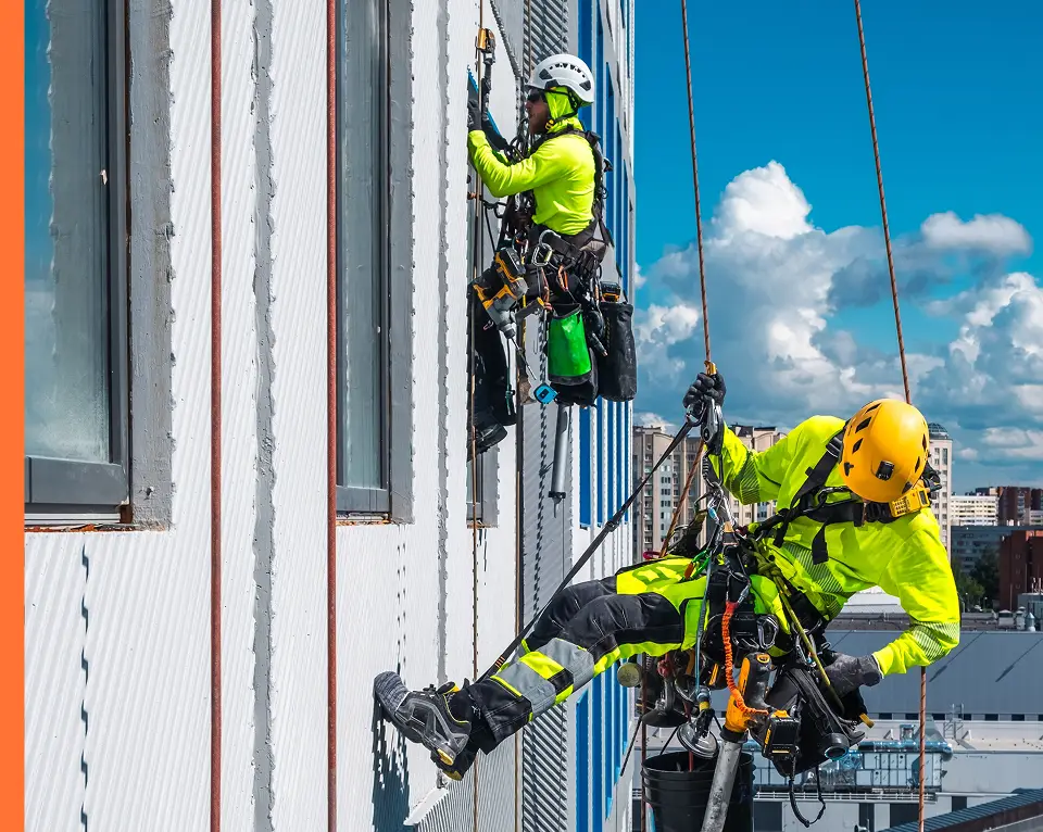 Safety workers scaling the side of a building