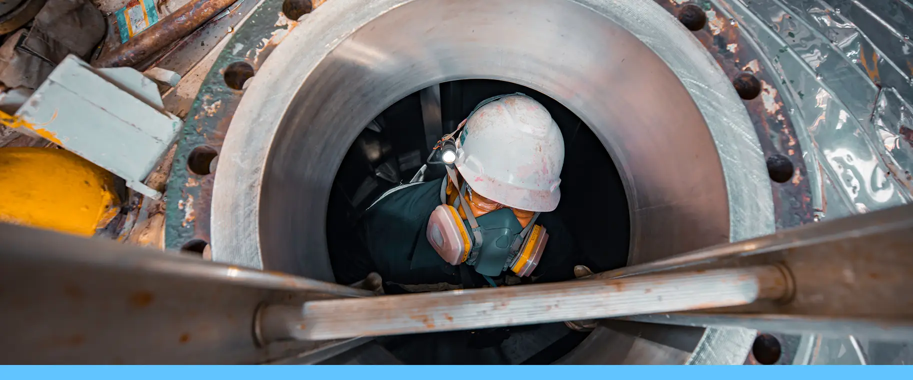 man climbing ladder into confined space