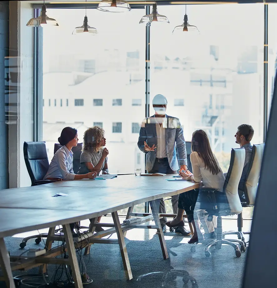 five people inside glass walled board room