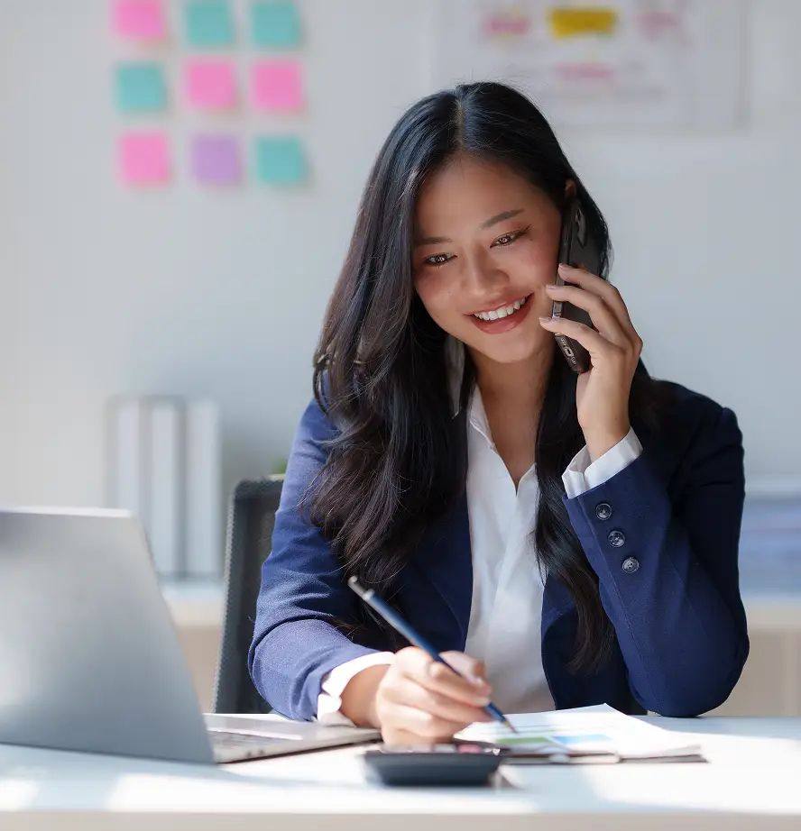 Office worker on telephone taking notes