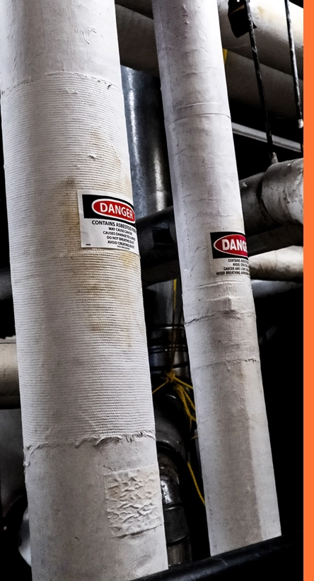 pipes wrapped in asbestos with danger sign displayed